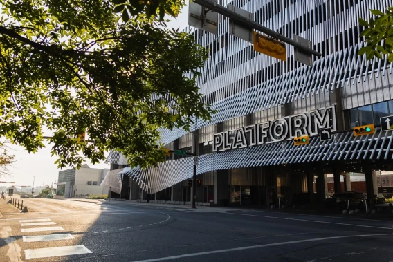 Street view of the Platform building exterior with signage, trees, and modern facade details.