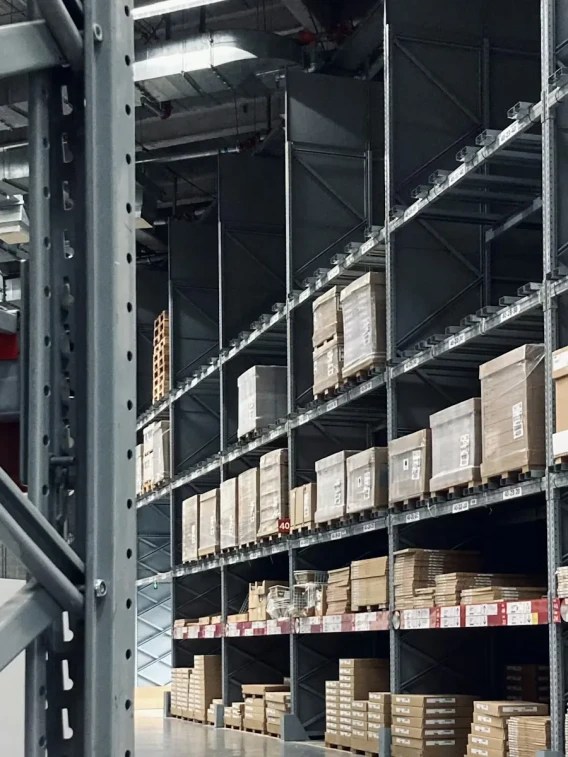 Tall warehouse storage racks filled with pallets and boxed inventory.